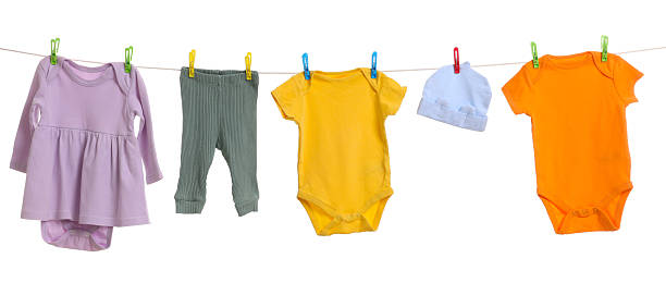 istock Different baby clothes drying on laundry line against white background 2238380712