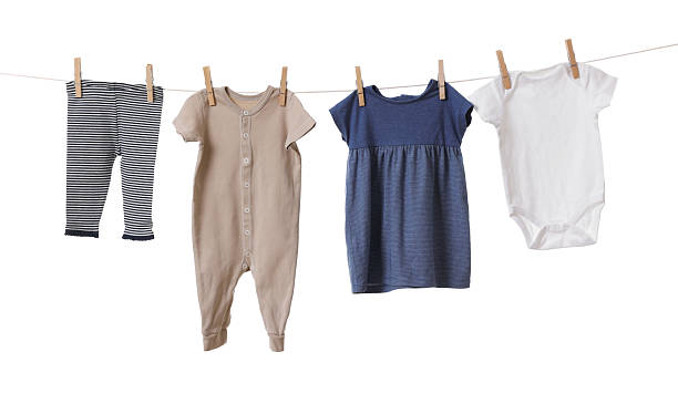 istock Different baby clothes drying on laundry line against white background 2238380754