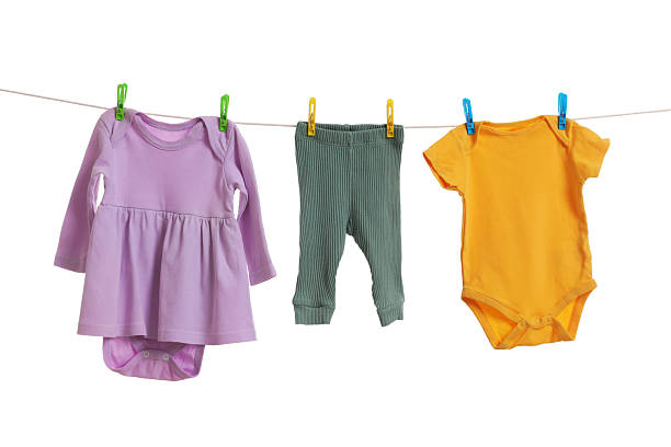 istock Different baby clothes drying on laundry line against white background 2238380757