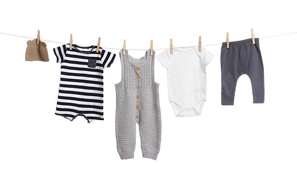 istock Different baby clothes drying on laundry line against white background 2238380830