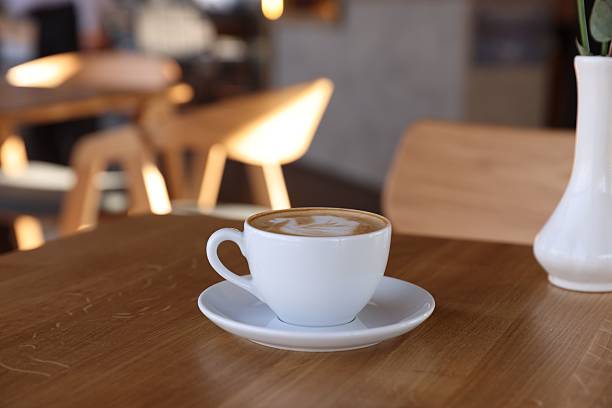 istock Cup of aromatic coffee on wooden table in cafe 2238381042