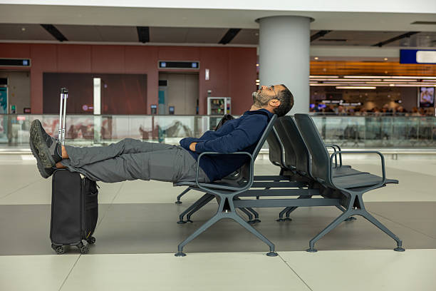 istock Man sleeping at the airport 2238381097