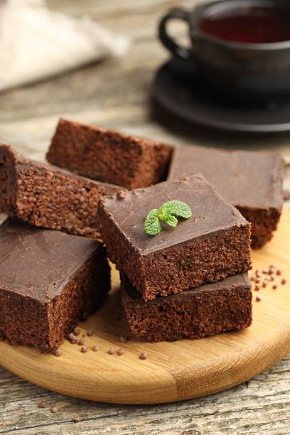 istock Delicious chocolate puffed rice bars and tea on wooden table, closeup 2238384255