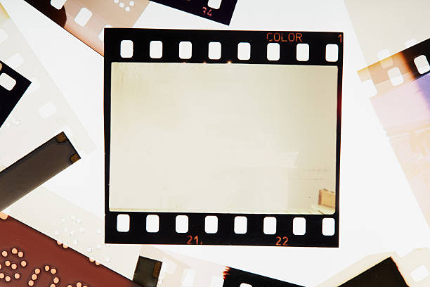 istock Blank vintage film negative surrounded with blank frames. Noise, grain and scratches 2238384452