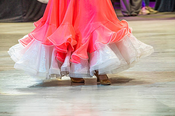 young dancer in a pink and white dress dances a standard dance program on the floor, 10 dances