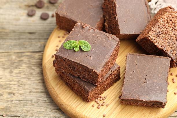 istock Delicious chocolate puffed rice bars and mint on wooden table, closeup 2238384577