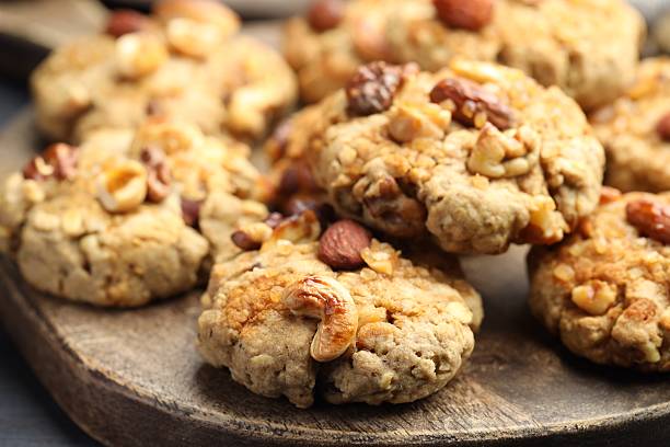 istock Tasty cookies with nuts on table, closeup 2238384611