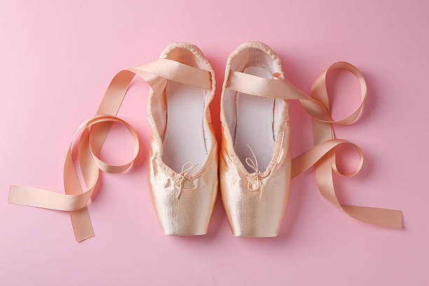 istock Pair of beautiful pointe shoes on pink background, top view 2238388814