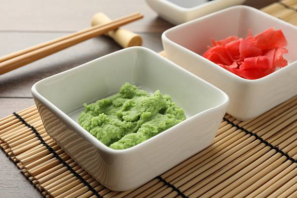 istock Hot wasabi paste, ginger and chopsticks on wooden table, closeup 2238389262