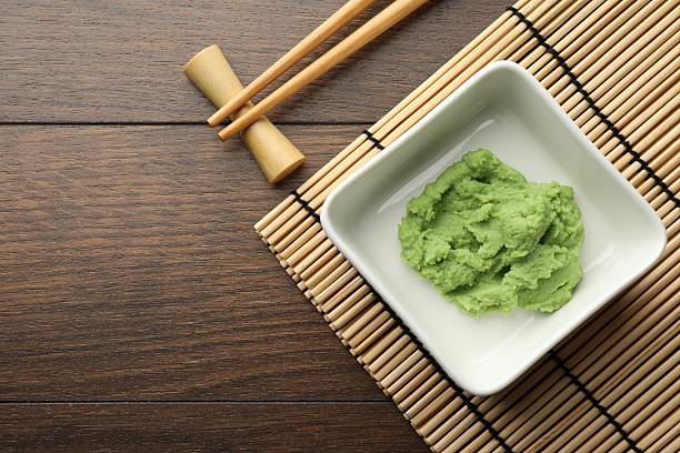 istock Hot wasabi paste and chopsticks on wooden table, top view. Space for text 2238389294