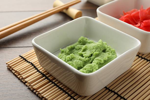 istock Hot wasabi paste, ginger and chopsticks on wooden table, closeup 2238389316
