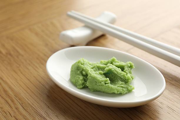 istock Hot wasabi paste and chopsticks on wooden table, closeup 2238389325