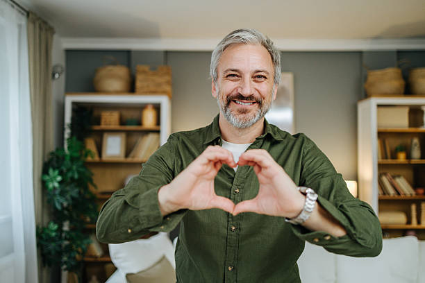 istock Mature adult man gesturing heart shape with hands 2238389685