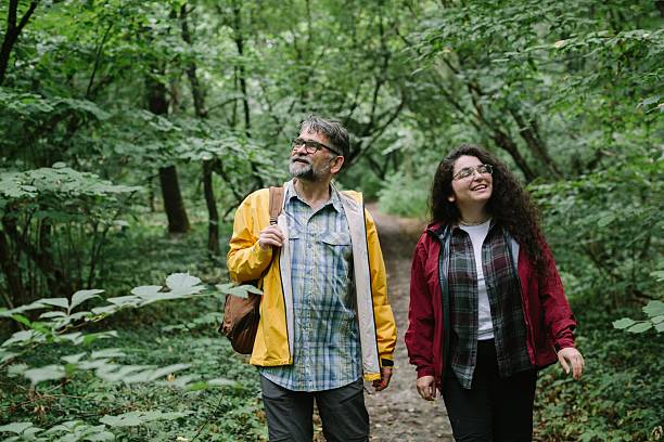 istock Father daughter enjoying nature walk forest trail 2238390596