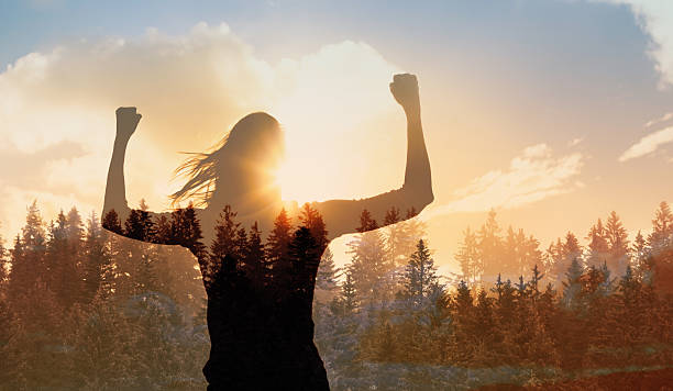 istock Young strong woman outdoors finding inner strength power vision winning mindset flexing facing the sun. 2238390723