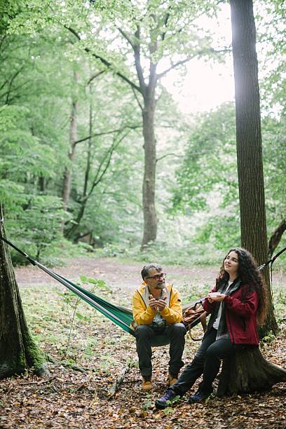 istock Father and daughter relaxing in forest during hike 2238391397