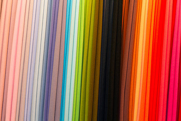 istock Multicolored textile material in a row on the store counter 2238393189