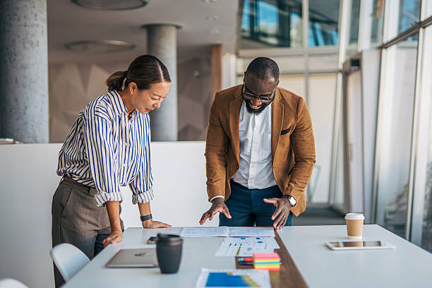 istock Diverse business partners collaborating on project in modern office 2238394397