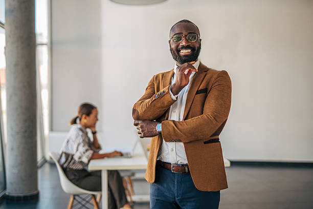 istock Confident businessman smiling in modern coworking office 2238394411