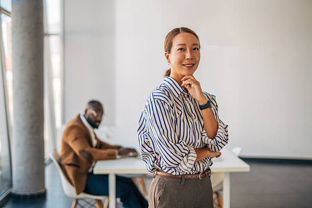 istock Confident businesswoman smiling in modern office environment 2238394626