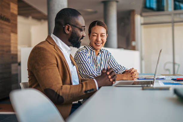 Diverse business partners smiling during office meeting collaboration
