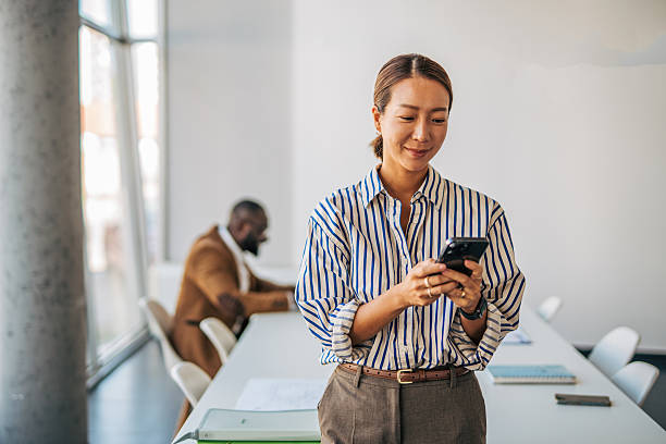 istock Businesswoman using smartphone in meeting room 2238396868