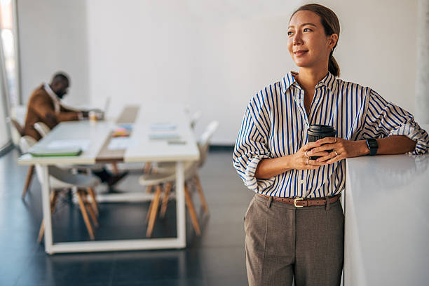 istock Professional woman taking coffee break in modern office 2238397038