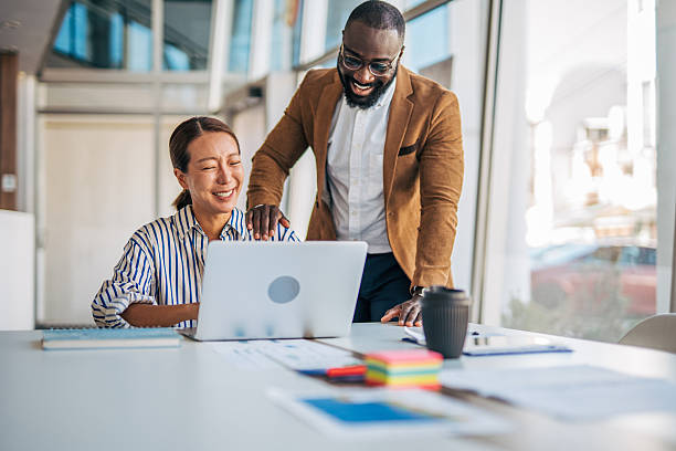 istock Diverse business team collaborating and laughing in office 2238397048