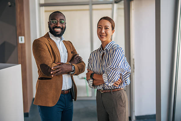 istock Diverse business partners standing together in modern office 2238398654