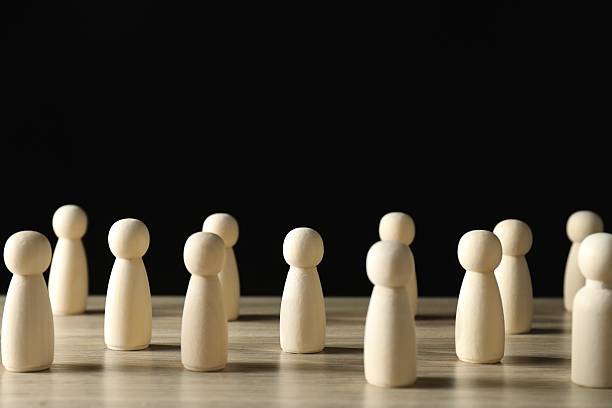 istock Human resources concept. Many wooden figures on table against dark background, closeup. Space for text 2238399595