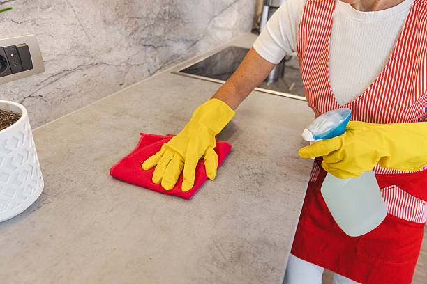 istock Cleaning Action In Modern Kitchen With Yellow Gloves Wiping Counter Using Spray Bottle For Maintenance 2238400453