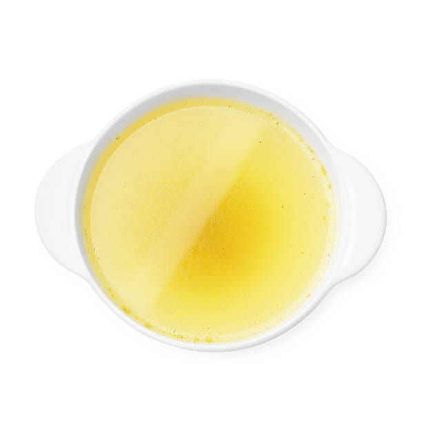 istock Tasty chicken bouillon in bowl isolated on white, top view 2238400509
