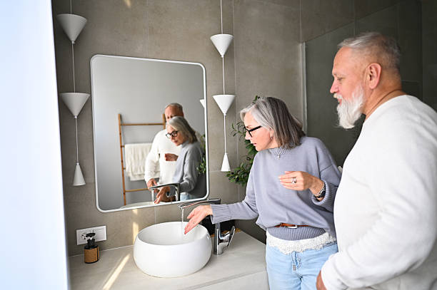 istock Senior couple washing hands in modern bathroom 2238400949