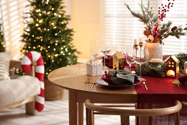 Preparing for Christmas Eve at beautifully decorated table.