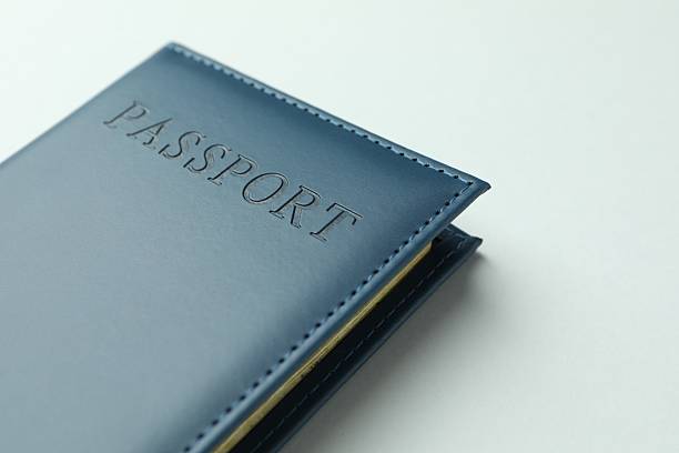 istock Passport in dark blue cover on light background, closeup. Space for text 2238402341