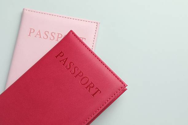 istock Passports in color covers on light background, closeup. Space for text 2238402355