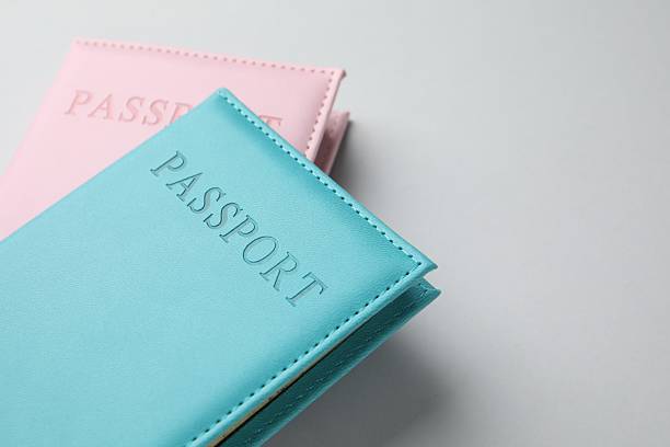 istock Passports in color covers on light background, closeup. Space for text 2238402367