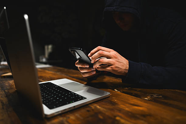 istock Anonymous hacker using smartphone and laptop, cybercrime concept. wannacry ransomware attack 2238402798