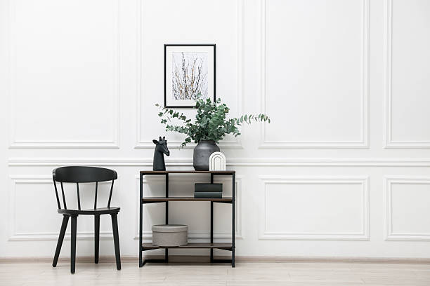 istock Console table with decor and chair near white wall in room, space for text. Interior design 2238403087