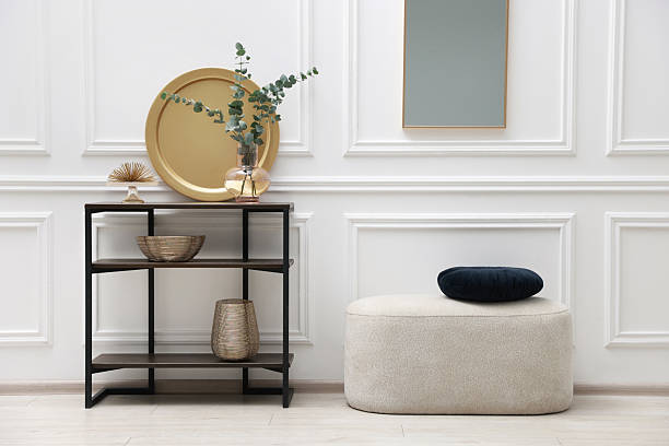 istock Console table with decor, pouf and mirror in room. Interior design 2238403187
