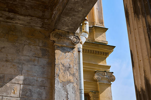 Delving into the intricate and captivating details of a weathered architectural column set against a bright blue sky