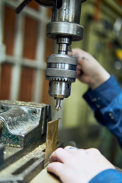 istock View of a Latina woman's hands working in a workshop, using machinery, a press, tools, bending, drilling 2238409833