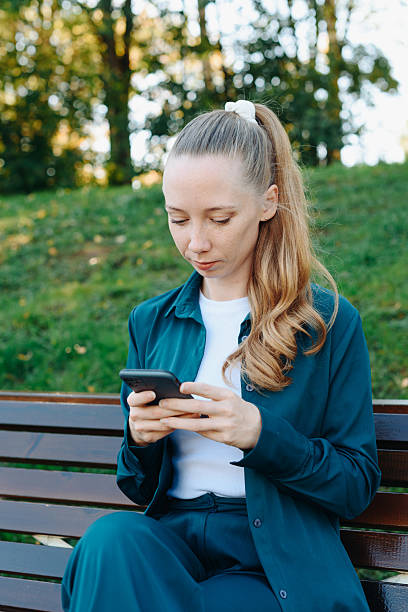 istock young woman holds smartphone in hands 2238411893