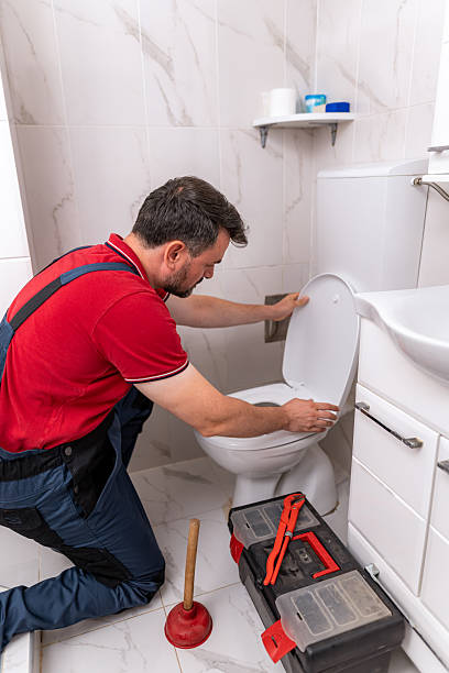 istock Plumber repairing toilet in bathroom using tools during daytime work session 2238412744