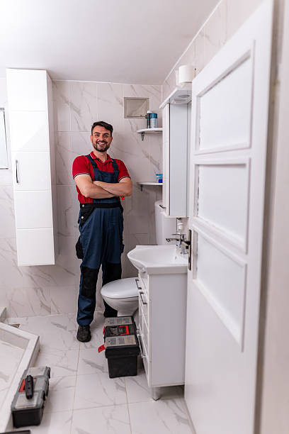 istock Plumber in a modern bathroom ready for work with tools at hand and a confident smile 2238412845