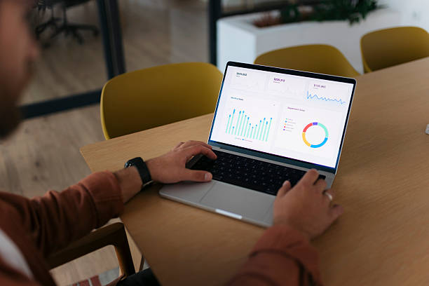 istock Person analyzing business data on laptop in office 2238416950