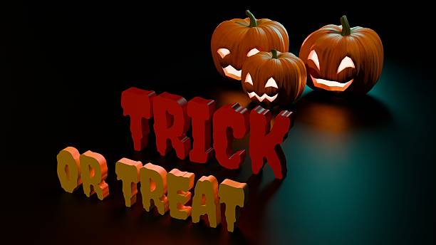 istock Glowing jack o lantern pumpkins with Trick or Treat red text design 2238417767