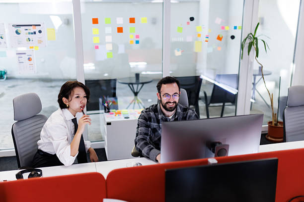 istock Business professionals collaborate in a modern office setting while discussing ideas and reviewing projects at their workspace in the afternoon 2238424274