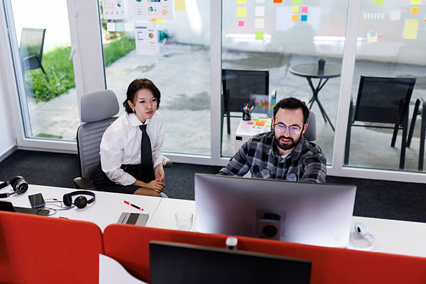 istock Business professionals collaborate in modern office during a meeting to discuss project details and share insights, fostering teamwork and innovation 2238424280