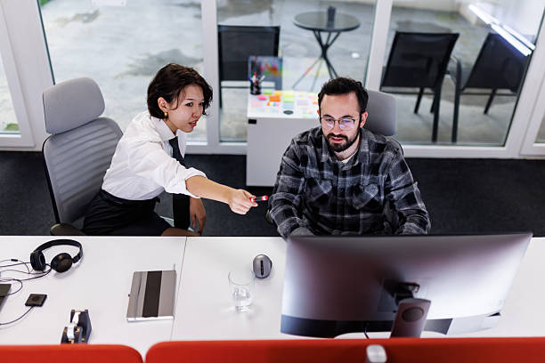 istock Businesspeople collaborating in a modern office environment working on a project during the day, with screens reflecting their teamwork and ideas 2238424291